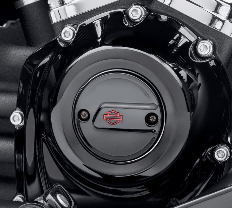 Harley-Davidson Accessories Kahuna Timer Cover in gloss black. The Harley-Davidson Kahuna Collection's rich, gloss black surface is interrupted by a powerful raised bridge that draws the eye from leading to trailing edge. Gloss black finish with a red Bar & Shield logo. Includes black zinc mounting hardware.