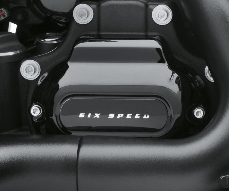 Harley-Davidson Accessories Transmission Side Cover 6-Speed in gloss black. This engine cover is the perfect start in converting your powertrain to an elegant "tuxedo black" look. Gloss black with "Six Speed" lettering. Manufactured from Original Equipment components to ensure a perfect fit, and coated with temperature-resistant paint for a long-lasting finish. Critical surfaces are masked to provide a good gasket seal.