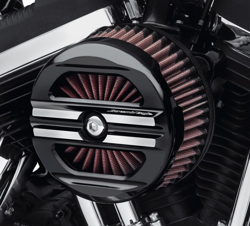 Harley-Davidson Accessories The look is bold and the performance exhilarating. This race-inspired air cleaner is engineered to flow through the perimeter and the face of the air filter, providing high volumes of unrestricted airflow to the engine. The open-design face plate features a rich black finish with machined longitudinal strakes to expose the glowing aluminum below. Includes air cleaner trim, one-piece cast back plate, high-flow washable air filter element, rain sock and all required hardware. Gloss Black finish.