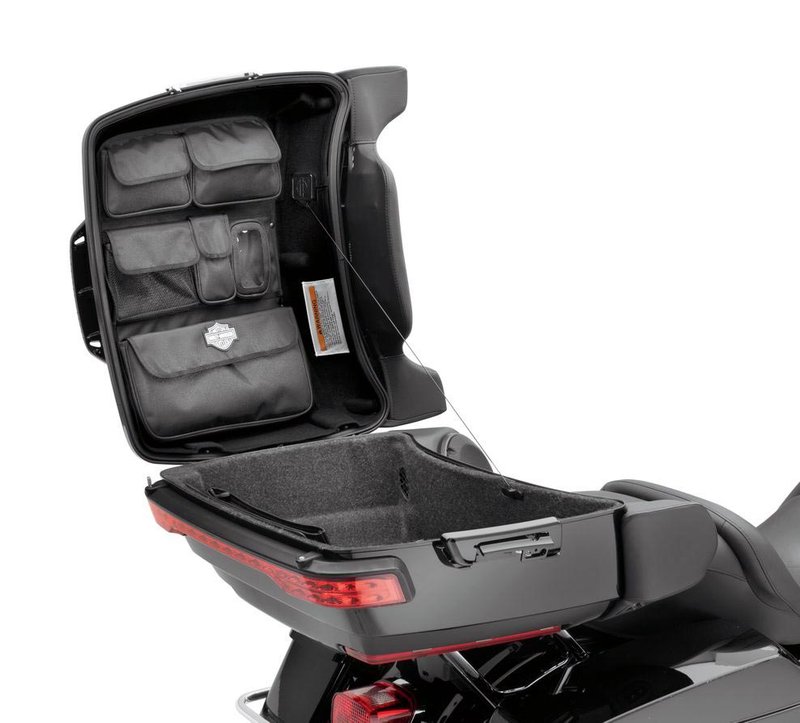 Harley-Davidson Accessories Tour-Pak Lid Fitted Lining with Organizer, Premium black. This premium lid lining features a soft-touch black felt finish to reduce noise, plus a series of storage pouches that provide easy access to your essentials. Four flap pouches and one mesh and one clear pocket provide plenty of storage, and hook-and-loop fasteners secure the one-piece formed lining to the lid. Fits '14-later FLHTCU, FLHTK, FLHTCUTG and models equipped with King or Chopped Tour-Pak luggage.