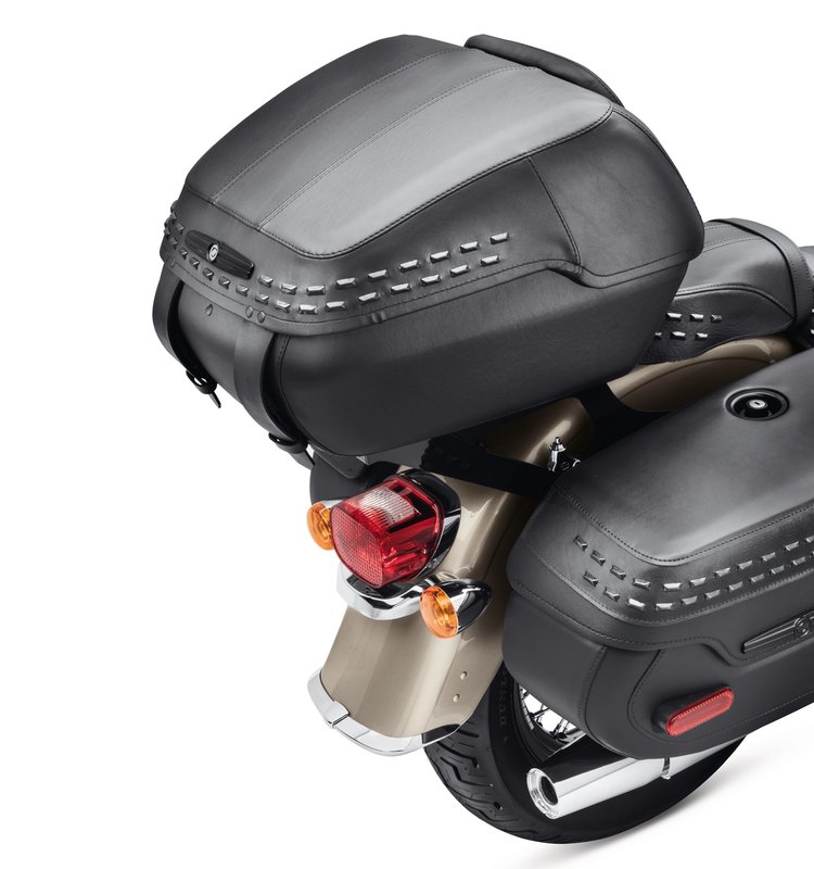Harley-Davidson Accessories Tour-Pak Luggage, Heritage Style. When you're serious about racking up miles, the Tour-Pak luggage system helps you pack for the trip, carrying rain gear, clothing and camping equipment for a long ride or groceries for a quick run to the store. When you arrive, the Tour-Pak and its HoldFast mounting rack can be removed in seconds to return the bike to a stripped-down profile. The hard-shell body and lid open to a cavernous interior that holds one full-face helmet or two half helmets. Finished in black, wrapped in rich long-wearing vinyl and accented with twin rows of blacked-out rectangular studs, it is a perfect match for the seats and saddlebags on the Softail Heritage model. The rigid-body Tour-Pak features a lockable lid for added security and includes a matching backrest pad. Luggage capacity: 2,580 cubic inches. Mounting racks and docking kits sold separately. Fits Softail '18-later models (except Fat Boy FLFB/FLFBS, FXDR, and Breakout FXBR/FXBRS) with a HoldFast Detachable Solo or Two-Up Tour-Pak mounting rack.