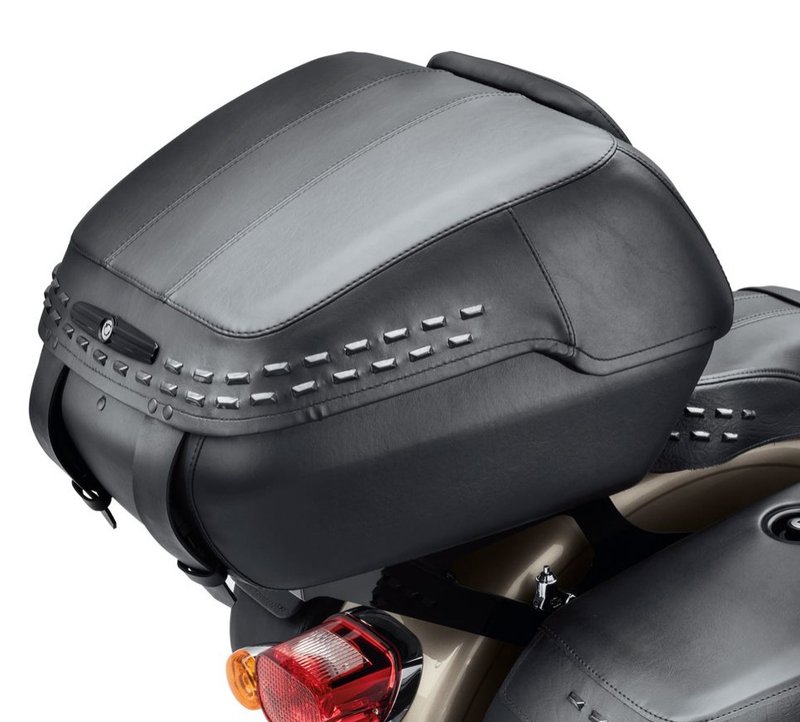 Harley-Davidson Accessories Tour-Pak Luggage, Heritage Style. When you're serious about racking up miles, the Tour-Pak luggage system helps you pack for the trip, carrying rain gear, clothing and camping equipment for a long ride or groceries for a quick run to the store. When you arrive, the Tour-Pak and its HoldFast mounting rack can be removed in seconds to return the bike to a stripped-down profile. The hard-shell body and lid open to a cavernous interior that holds one full-face helmet or two half helmets. Finished in black, wrapped in rich long-wearing vinyl and accented with twin rows of blacked-out rectangular studs, it is a perfect match for the seats and saddlebags on the Softail Heritage model. The rigid-body Tour-Pak features a lockable lid for added security and includes a matching backrest pad. Luggage capacity: 2,580 cubic inches. Mounting racks and docking kits sold separately. Fits Softail '18-later models (except Fat Boy FLFB/FLFBS, FXDR, and Breakout FXBR/FXBRS) with a HoldFast Detachable Solo or Two-Up Tour-Pak mounting rack.