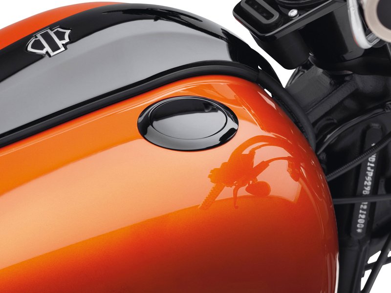 Harley-Davidson Accessories Emphasise the long, lean look of the fuel tank with this original Harley-Davidson flush mount fuel cap. The kit offers a pop-up filler design that replaces the original equipment twist-on fuel cap; a simple push and the filler cap pops up to provide ample grip, even while wearing gloves. Easy to install, the cap assembly screws into position and the self-adhesive decorative ring finishes the look. The complete kit includes a screw-in mount, pop-up cap and matching trim ring. Gloss black finish.