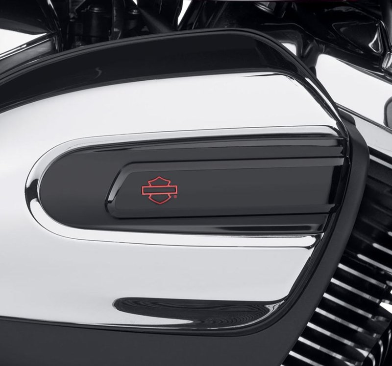 Harley-Davidson Accessories Kahuna Air Cleaner Trim in black. The Harley-Davidson Kahuna Collection's rich, gloss black surface is interrupted by a powerful raised bridge that draws the eye from leading to trailing edge. Gloss black finish with a red Bar & Shield logo.