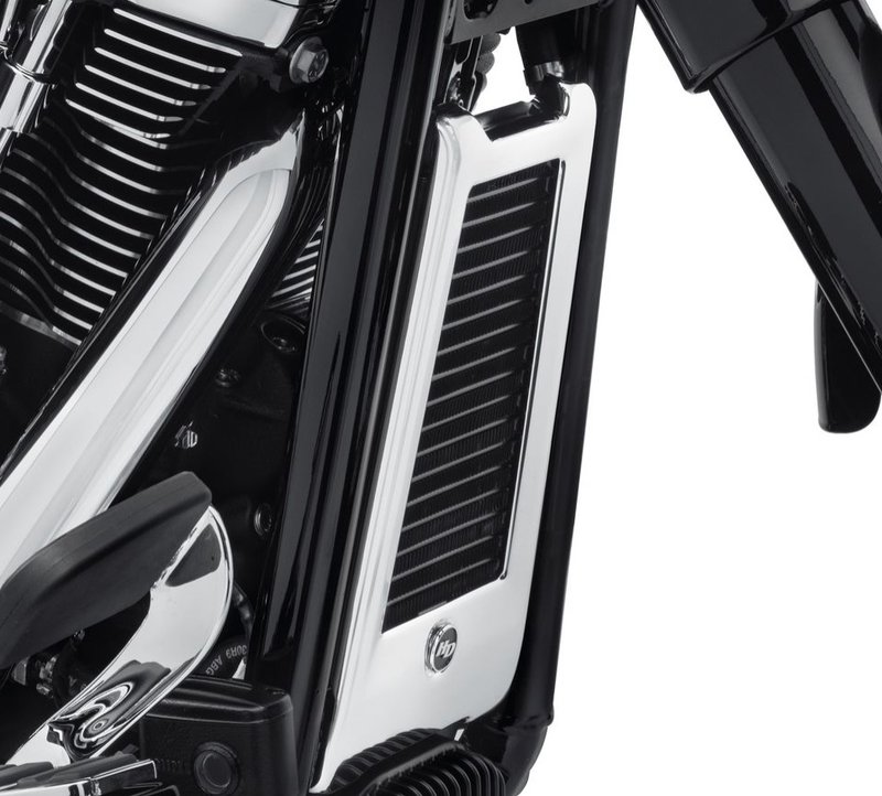 Harley-Davidson Accessories Oil Cooler Cover in chrome. Dress the oil cooler in style. The cover fills the area between the frame downtubes for a complete custom look, without disturbing the airflow across the cooler's surface. It replaces the plastic surround, and because it hugs the contours of the cooler body, it does not interfere with engine guard installation. Chrome finish, easy to install, and includes all required mounting hardware.