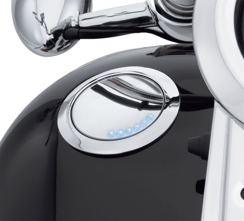 Harley-Davidson Accessories Emphasise the long, lean look of the fuel tank. This flush mount fuel cap and gauge kit offers a pop-up filler design that, when installed and sealed, looks identical to the flush gauge; a simple push and the filler cap pops up to provide ample grip, even while wearing gloves. The flush fuel gauge features individual LED lamps that shine through a mirror-coated glass which glows when the ignition is switched on. A photocell automatically adjusts LED brightness for improved visibility in direct sunlight, and dims at night to avoid distraction. The complete kit includes a fuel cap, fuel gauge, trim ring and plug-in wiring harness. Chrome finish.