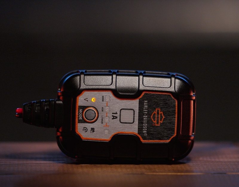 Harley-Davidson Accessories Avoid the dead battery blues with a new Harley-Davidson Dual-Mode Battery Charger. Ideal for today's popular motorcycle battery technologies, this charger can automatically charge and maintain Harley-Davidson Lithium LiFe or AGM Lead-Acid batteries, and just about any other battery in your home shop. It will effortlessly charge multiple battery voltages (6 and 12 volt) with chemistries such as flooded, gel, AGM and Lithium. You can also charge different types of batteries such as deep-cycle, marine, powersport and more. The charger is completely automatic. You can leave it plugged in 24/7 with no worries of overcharging, and no technical knowledge is required. Designed for use in any climate, it alters each charge based on the ambient temperature for a more accurate recharge. This fully-automatic charger is ideal for short- or long-term motorcycle battery charging needs. - For use within Europe and the Middle East - Selectable charge options provide optimal charging for Harley-Davidson Lithium LiFe or AGM Lead-Acid batteries - Can be used to charge 12 volt and 6 volt batteries - Can be used with existing Harley-Davidson battery charging cords - no additional charging cords needed - Maximum charge rate of 1 amp - Harley-Davidson tested and validated - Backed by a 5-year limited warranty