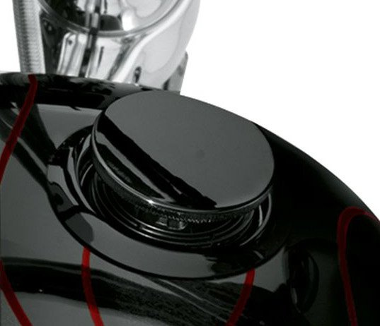 Harley-Davidson Accessories Emphasise the long, lean look of the fuel tank with this original Harley-Davidson flush mount fuel cap kit. This flush mount fuel cap and gauge kit offers a pop-up filler design that, when installed and sealed, looks identical to the flush gauge; a simple push and the filler cap pops up to provide ample grip, even while wearing gloves. The flush fuel gauge features individual LED lamps that shine through a mirror-coated glass which glows when the ignition is switched on. A photocell automatically adjusts LED brightness for improved visibility in direct sunlight, and dims at night to avoid distraction. The complete kit includes a fuel cap, fuel gauge, trim ring and plug-in wiring harness. Gloss black finish.