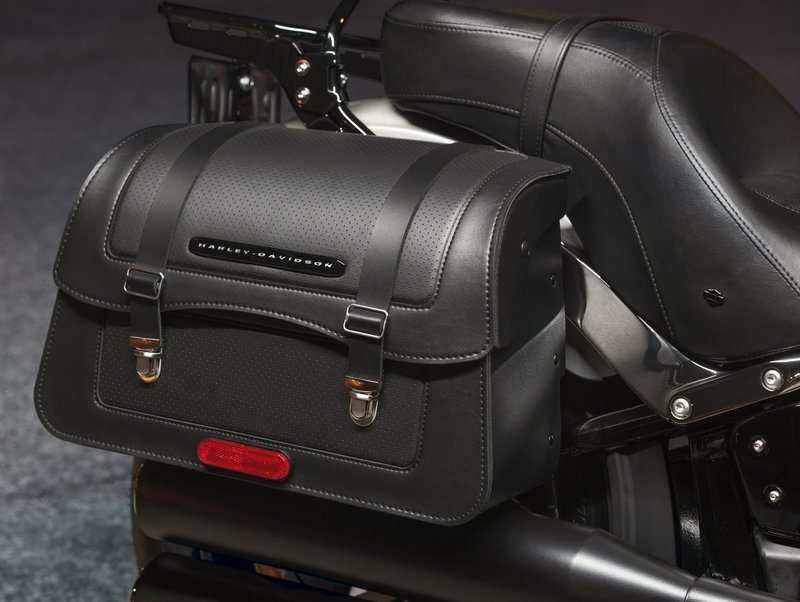 Harley-Davidson Accessories Detachables Saddlebag, black vinyl. Sized for the commute to work or a ride across the country, these modern waterfall-style bags complement the stripped-down look of the Softail cruiser models. They are completely removable with a simple pull of the internal handle and a rearward slide, leaving the bike unencumbered, and when removed they leave behind simple, inconspicuous docking points. Features a flip-back lid, a reinforced vinyl-wrapped body with perforated-style panels, a nickel/silver finish with nickel snap-to-close hardware, and a black chrome Harley-Davidson signature medallion. Complements stock and many accessory seats, and can be installed with HoldFast sissy bars and racks when equipped with model-specific docking hardware. Includes all required mounting hardware. Luggage capacity: 2,170 cubic inches. Fits Softail Slim FLSL, Street Bob FXBB/S, Standard FXST and Low Rider FXLR '18-later models.
