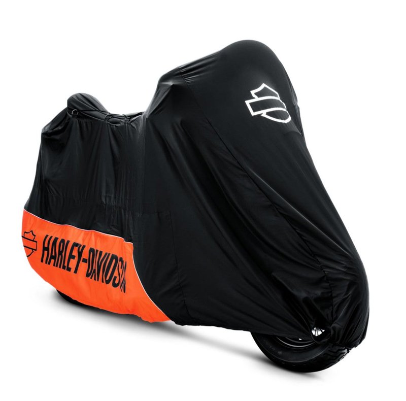 Harley-Davidson Accessories Pamper your bike. This luxuriously soft microfiber cover is ideal for short and long term indoor storage. - The breathable microfiber material promotes air circulation to reduce moisture build-up and minimize corrosion - Cover skirt features front and rear adjustable drawstrings to cinch the cover around the bike, and a convenient belly strap to reduce ballooning in the wind - The corset-style cinching system along the backbone lets you adjust the cover for best fit on a variety of models - The cover features heat-resistant panels that protect the material from warm exhaust, and the hook-and-loop opening at the rear of Touring covers accommodates antennas - The two-tone orange and black cover features reflective piping for added visibility, and an integrated storage pouch for convenient packing when not in use