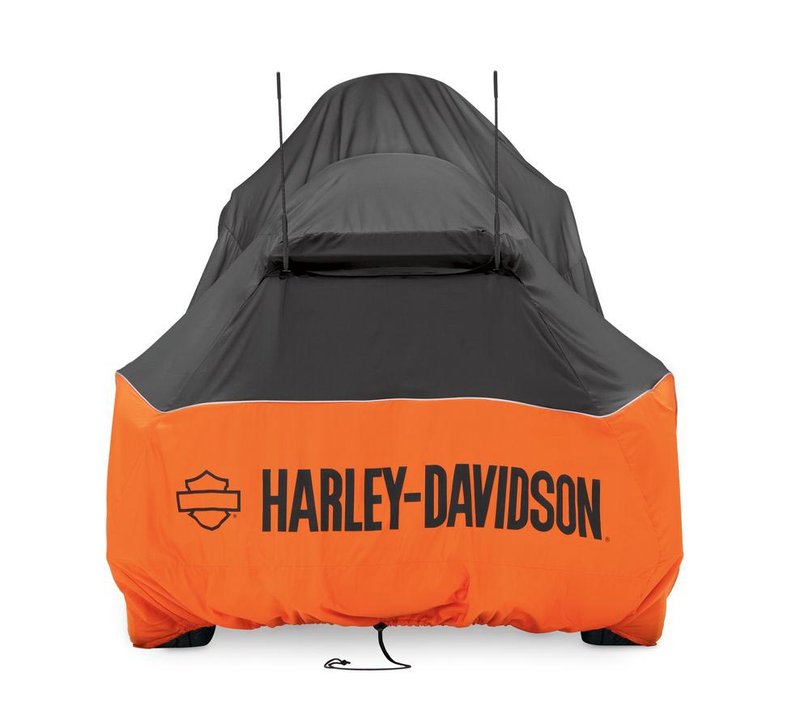 Harley-Davidson Accessories Pamper your bike. This luxuriously soft microfiber cover is ideal for short and long term indoor storage. - The breathable microfiber material promotes air circulation to reduce moisture build-up and minimize corrosion - Cover skirt features front and rear adjustable drawstrings to cinch the cover around the bike, and a convenient belly strap to reduce ballooning in the wind - The corset-style cinching system along the backbone lets you adjust the cover for best fit on a variety of models - The cover features heat-resistant panels that protect the material from warm exhaust, and the hook-and-loop opening at the rear of Touring and Trike covers accommodates antennas - The two-tone orange and black cover features reflective piping for added visibility, and an integrated storage pouch for convenient packing when not in use