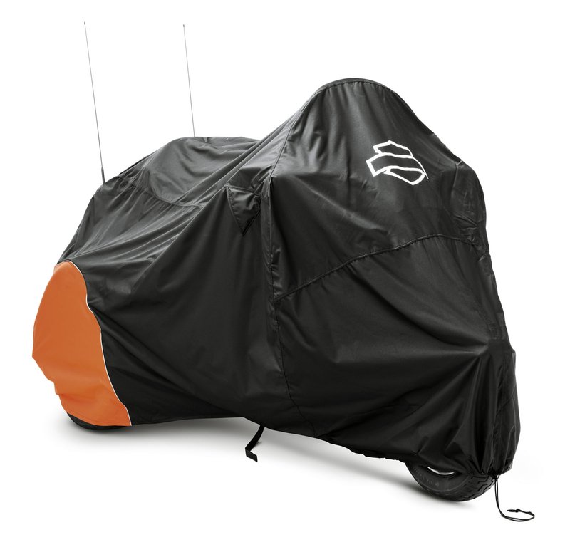 Harley-Davidson Accessories Guard your trike from Mother Nature. Perfect for a bike that is exposed to the elements, this heavy duty cover is manufactured from diamond-pattern 300 Denier fade-resistant polyester and features taped seams for water resistance. - The weather-shielded vents in the top of the cover promote air circulation to reduce moisture build-up and minimize corrosion during short or long term storage - Internal heat-resistant panels protect the cover from warm exhaust and an integrated storage pouch permits convenient packing when not in use - The cover skirt features front and rear adjustable drawstrings to cinch the cover around the bike, and a convenient belly strap to reduce ballooning in the wind - The corset-style cinching system along the backbone lets you adjust the cover for best fit on a variety of models, and the hook-and-loop opening on Touring and Trike covers accommodates antennas - Available in your choice of two-tone orange and black or inconspicuous plain black finish, the cover features reflective piping for added visibility