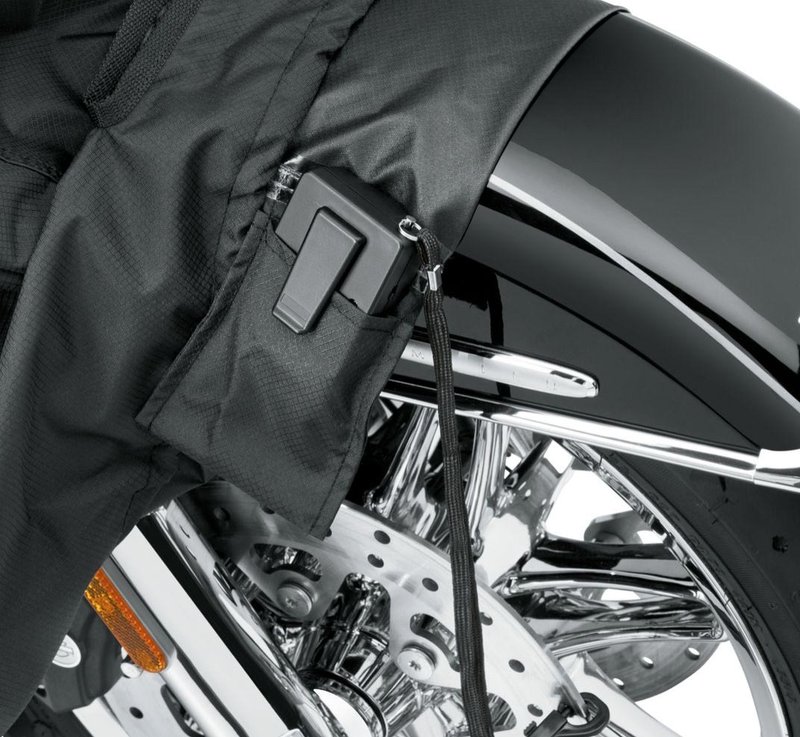 Harley-Davidson Accessories Guard your trike from Mother Nature. Perfect for a bike that is exposed to the elements, this heavy duty cover is manufactured from diamond-pattern 300 Denier fade-resistant polyester and features taped seams for water resistance. - The weather-shielded vents in the top of the cover promote air circulation to reduce moisture build-up and minimize corrosion during short or long term storage - Internal heat-resistant panels protect the cover from warm exhaust and an integrated storage pouch permits convenient packing when not in use - The cover skirt features front and rear adjustable drawstrings to cinch the cover around the bike, and a convenient belly strap to reduce ballooning in the wind - The corset-style cinching system along the backbone lets you adjust the cover for best fit on a variety of models, and the hook-and-loop opening on Touring and Trike covers accommodates antennas - Available in your choice of two-tone orange and black or inconspicuous plain black finish, the cover features reflective piping for added visibility