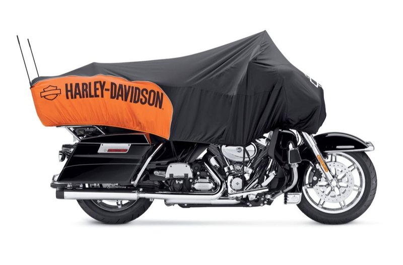 Harley-Davidson Accessories Keep your seat dry when you stop for the night. Lightweight and compact for travel, this easy-to-store cover rolls into the built-in bag. - Made from soft microfiber, the black and orange water repellent fabric dries quickly for a quick getaway - Hook-and-loop closures in the rear let you slip the cover over your antennas, and the elastic bottom hem and footboard stirrups ensure a snug fit - The "Harley-Davidson" script and Bar & Shield logo prominently stand out on the fabric