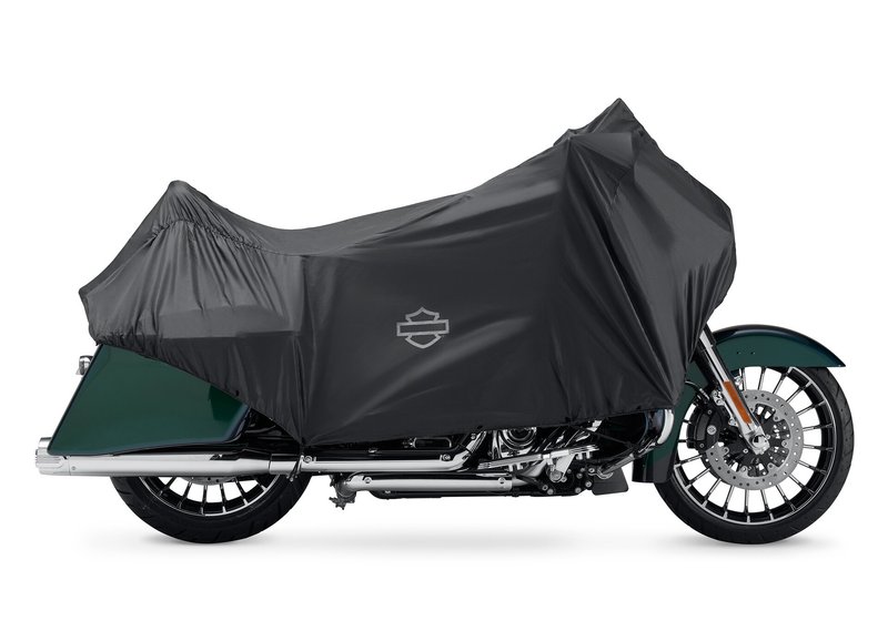 Harley-Davidson Accessories Travel with protection. This lightweight, water-resistant Compact Travel Cover is easy to pack and covers the main motorcycle touch points from the windshield to the rear seating area. - Compact and lightweight cover stores in its own pouch and requires over 40% less luggage space than a full-size motorcycle cover, so it's easy to pack along "just in case" - When compacted in pouch, the travel cover takes up less space than a 64 oz aluminum drink container - Multiple attachment options to adjust the fit based on motorcycle model and luggage option so the cover can be used on different bikes - Minimizes motorcycle wipe-down after dew or light rain - Discourages tampering with the covered motorcycle for an added layer of security - Reflective logos highlight the front, rear, and sides of the vehicle for added visibility when the motorcycle is parked at night - Made from polyester with a water-resistant polyurethane coating