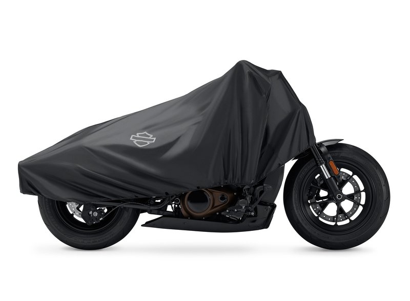 Harley-Davidson Accessories Travel with protection. This lightweight, water-resistant Compact Travel Cover is easy to pack and covers the main motorcycle touch points from the windshield to the rear seating area. - Compact and lightweight cover stores in its own pouch and requires over 40% less luggage space than a full-size motorcycle cover, so it's easy to pack along "just in case" - When compacted in pouch, the travel cover takes up less space than a 64 oz aluminum drink container - Multiple attachment options to adjust the fit based on motorcycle model and luggage option so the cover can be used on different bikes - Minimizes motorcycle wipe-down after dew or light rain - Discourages tampering with the covered motorcycle for an added layer of security - Reflective logos highlight the front, rear, and sides of the vehicle for added visibility when the motorcycle is parked at night - Made from polyester with a water-resistant polyurethane coating
