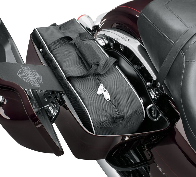 Harley-Davidson Accessories Premium Travel-Pak. These bags are made of water-resistant ballistic nylon that matches the premium luggage collection. The exterior features comfortable carrying handles, heavy-duty glove-friendly zippers, a zippered pocket, D-rings for optional carrying straps, and 3M Scotchlite reflective trim. Fits '93-later Touring models with hard saddlebags.