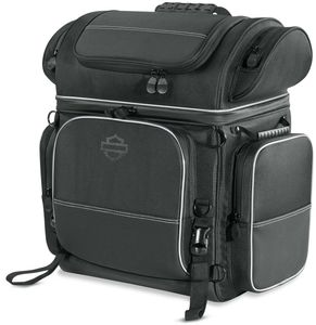 Harley-Davidson Accessories Onyx Premium Touring Bag. Part of the Onyx Premium Luggage Collection, this Touring Bag is built for long-haul trips. It features a separate top compartment to keep your shoes apart from your clothes, a main compartment large enough for two weeks of jeans and t-shirts, and removable lid straps that stop the top compartment falling forward or back when loading. The large front pocket holds keys, pens, documents and small electronics, two upper outer pockets suit eyewear, and two large lower exterior pockets are ideal for rain gear. Made of premium 1680-denier UV-stable ballistic polyester that stands up to tough road and weather conditions without fading. Features water-resistant zippers with glove-friendly pulls, a burnt-orange interior for easy visibility, MOLLE-style webbing for modular pouch attachment, a non-slip abrasion-resistant base and reflective piping. Dimensions: 19.2" W x 12.7" D x 20.5" T. Capacity: 3,500 cubic inches (57 litres). Includes a removable shoulder strap and a rain cover with an elastic hem and barrel-lock mechanism that stays put at highway speeds.