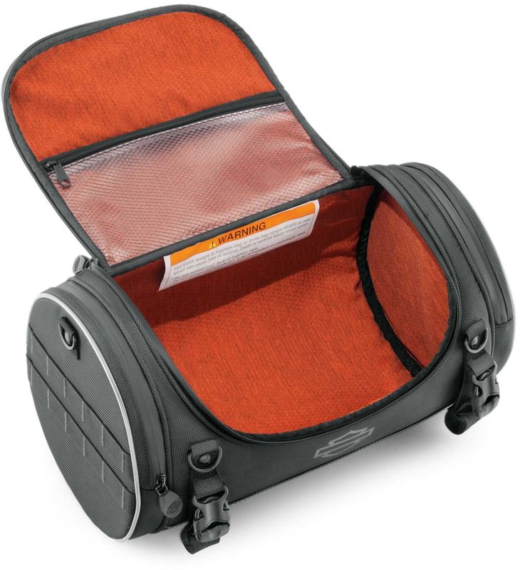 Harley-Davidson Accessories Onyx Premium Luggage Day Bag. Part of the Onyx Premium Luggage Collection, this compact Day Bag is ideal for the daily commute or a short day trip. The main compartment holds a sweatshirt, a pair of shoes, a rainsuit, gloves and a cap, while an interior mesh zip pocket keeps keys or small electronics handy. Its rigid structure keeps its shape even when empty, and the detachable padded shoulder strap makes it easy to carry. Made of premium 1680-denier UV-stable ballistic polyester that stands up to tough road and weather conditions without fading. Features water-resistant zippers with glove-friendly pulls, a burnt-orange interior for easy visibility, MOLLE-style webbing for modular pouch attachment, a non-slip abrasion-resistant base and reflective piping. Dimensions: 16.75" W x 9" D x 9" T. Capacity: 1,000 cubic inches (16 litres). Includes a removable shoulder strap and a rain cover with an elastic hem and barrel-lock mechanism that stays put at highway speeds. Fits models equipped with luggage racks (with or without a sissy bar upright) and Tour-Pak luggage racks (except Mini Rack P/N 53100-95).