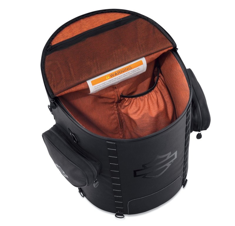 Harley-Davidson Accessories Onyx Premium Luggage Backseat Roller Bag. Part of the Onyx Premium Luggage Collection, this Backseat Roller Bag gives the solo rider durability, effortless transport and ample storage. Made of premium 1680-denier UV-stable ballistic polyester that stands up to tough road and weather conditions without fading. Features water-resistant zippers with glove-friendly pulls, a burnt-orange interior for easy visibility, MOLLE-style webbing for modular pouch attachment, and a non-slip abrasion-resistant base. A locking push-button handle extends to 20.5" and smooth-rolling skateboard wheels make it easy to move, while a large elastic pouch, a zippered mesh pocket and two outer stash pockets keep gear organised. Includes a rain cover with an elastic hem and barrel-lock mechanism that stays put at highway speeds, and is compatible with the Onyx Premium Luggage Rider Backrest Pad for long-haul comfort. Fits Touring and Trike '14-later models with a King Tour-Pak.