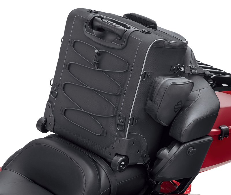Harley-Davidson Accessories Onyx Premium Luggage Backseat Roller Bag. Part of the Onyx Premium Luggage Collection, this Backseat Roller Bag gives the solo rider durability, effortless transport and ample storage. Made of premium 1680-denier UV-stable ballistic polyester that stands up to tough road and weather conditions without fading. Features water-resistant zippers with glove-friendly pulls, a burnt-orange interior for easy visibility, MOLLE-style webbing for modular pouch attachment, and a non-slip abrasion-resistant base. A locking push-button handle extends to 20.5" and smooth-rolling skateboard wheels make it easy to move, while a large elastic pouch, a zippered mesh pocket and two outer stash pockets keep gear organised. Includes a rain cover with an elastic hem and barrel-lock mechanism that stays put at highway speeds, and is compatible with the Onyx Premium Luggage Rider Backrest Pad for long-haul comfort. Fits Touring and Trike '14-later models with a King Tour-Pak.