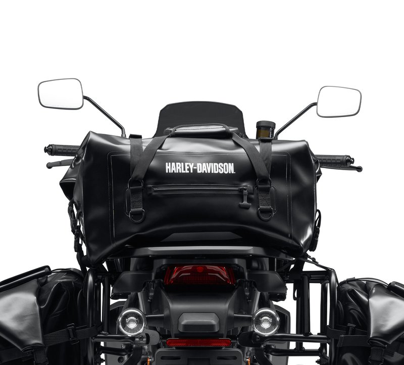 Harley-Davidson Accessories Adventure Duffel Bag. Intended for the hardcore off-road rider, this durable bag is designed for motorcycle use and resists damage if the bike tips over. The material is waterproof, the exterior pockets have waterproof zippers, and the roll-top closure creates a weather-tight seal so your gear stays dry in any conditions. The roll-top design and multiple compression straps let you cinch the load tightly for flexible capacity, and the bag is reflective for visibility in low light. The duffel can be secured to the Top Case Mounting Plate (sold separately) behind the seat, or on the passenger pillion in front of a hard case. Luggage capacity: 2,440 cubic inches (40 litres). Weight capacity: 22 lbs (10 kg). Size: 21" x 12" x 10". Includes universal mounting straps. Fits Pan America RA1250/S '21-later, and universal fitment.