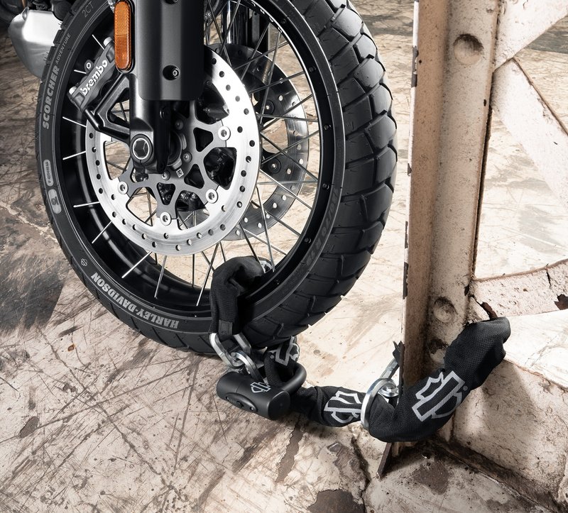 Harley-Davidson Accessories Maximum protection for your motorcycle. This high-security Noose Chain and Lock features a 12mm triple heat-treated boron manganese 6-sided link steel chain with a cinch ring for securing your bike to stationary objects. Put the chain around a post, slip the chain through the ring, and cinch it tight. Then loop the nylon-web covered chain through the frame or wheels of the bike and lock it up tight. - The lock features a fully removable 14mm shackle, a double deadbolt design for added security, a high-security lock cylinder with anti-float discs and nylon molded dust cover, and a lighted key for nighttime locking - The orange color gives the lock greater visibility for added theft deterrence - Thatcham Category 3 Approved